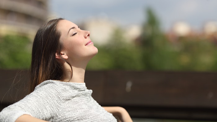 a woman breathing deeply while outside