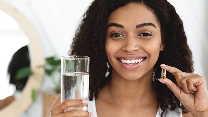Woman holding supplement