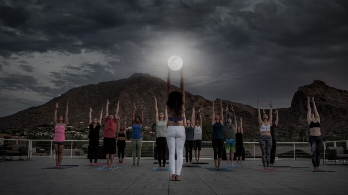 A Zodiac Yoga session taking place in the moonlight.