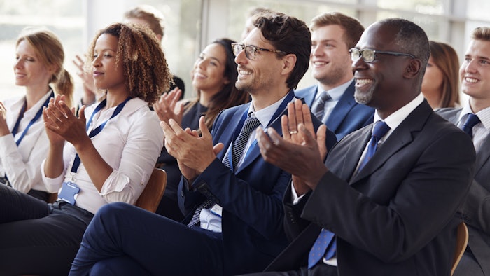 Conference attendees applauding