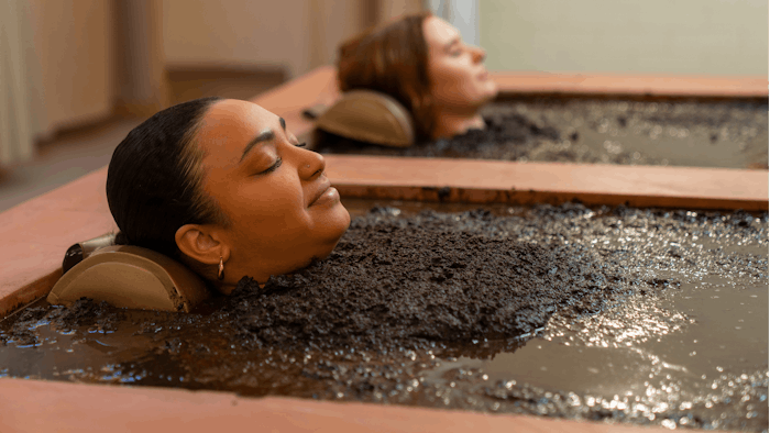 women soaking in Mud Baths at Dr. Wilkinson’s Backyard Resort & Mineral Springs