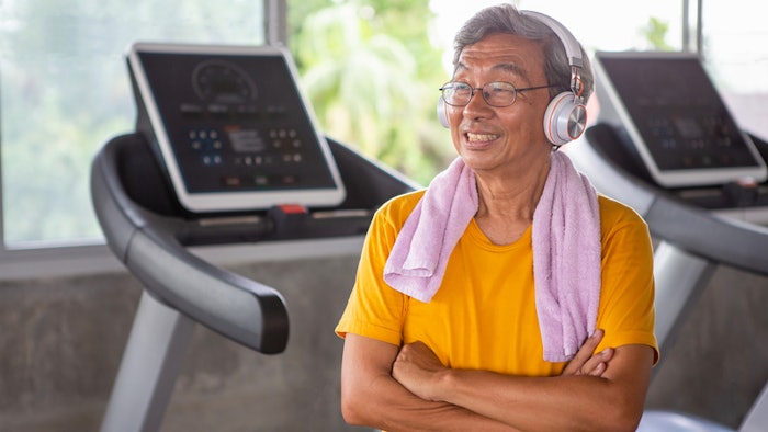 senior man at a gym, smiling after workout