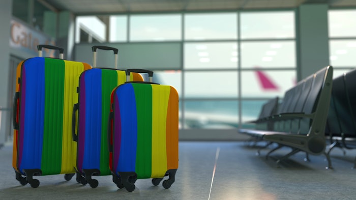 Travel suitcases with gay pride flag.