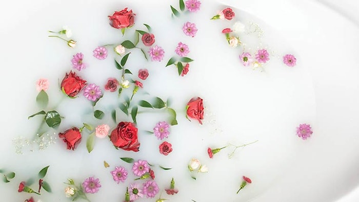 roses and flowers floating in a goat's milk bath