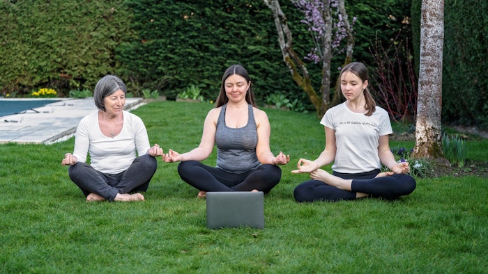 family partaking in online yoga class