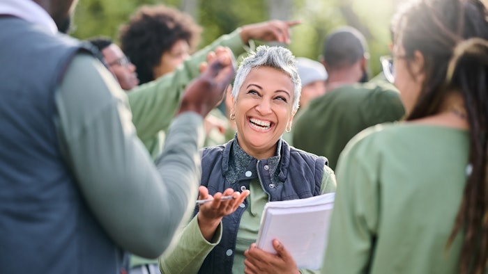Volunteer, team and people in nature for community service, teamwork and planning with leadership, goals and strategy. Senior person or leader for management in forest, park or eco friendly project