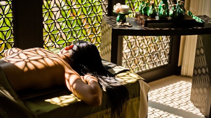 woman relaxing in aromatherapy spa treatment room