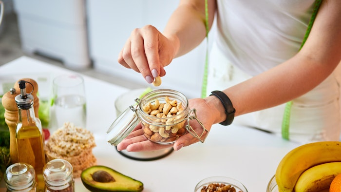 Young happy woman eating different healthy snacks